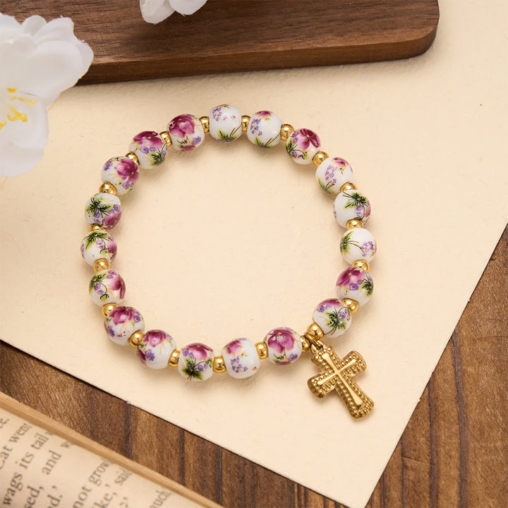 FREE Today: 4-Style Floral Ceramic Bead Stretch Bracelet with Gold-Tone Cross Charm: A Symbol of Gentle Heavenly Grace - Purple - image 0
